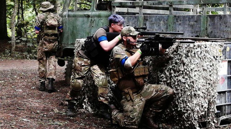 airsoft group using military truck as cover