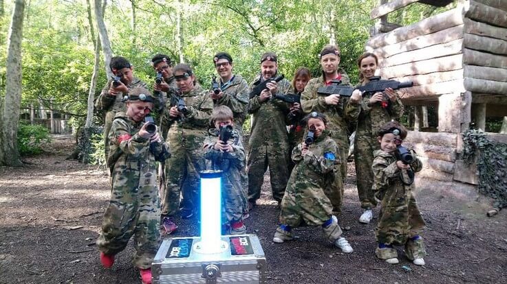 family playing outdoor laser tag