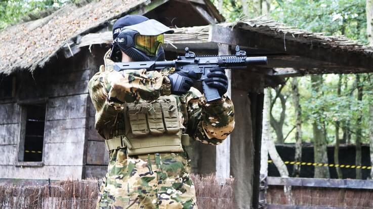 fully equipped airsofter in woodland game zone