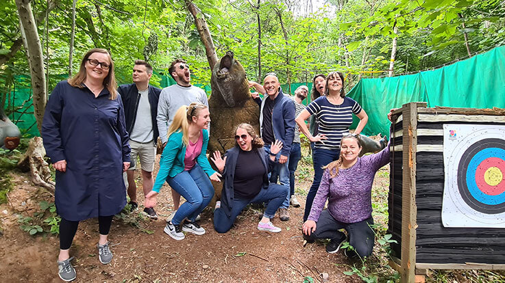 group in front of archery sign