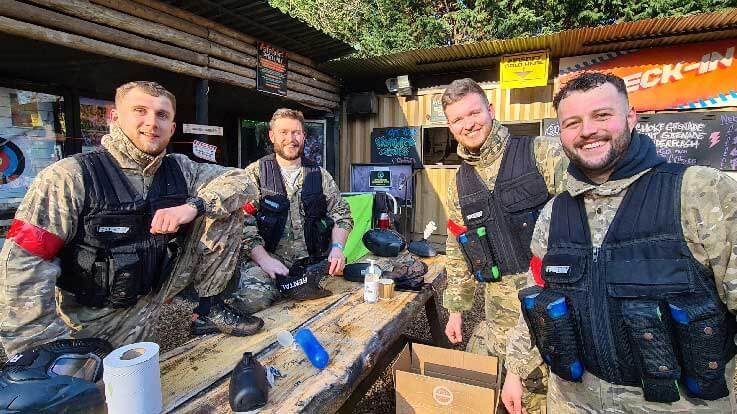 group of happy paintballers in the basecamp area