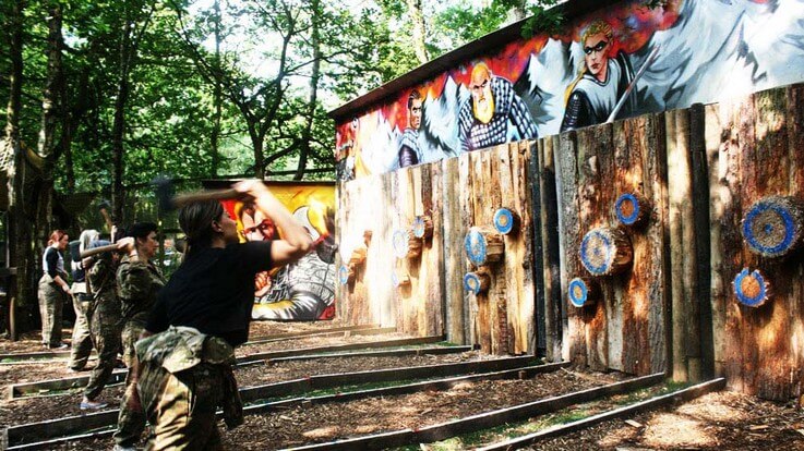 group of ladies throwing axes