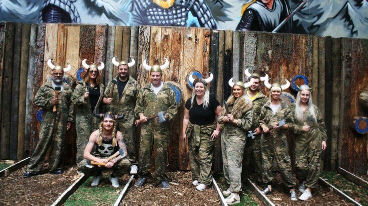 happy axe throwing group with viking hats