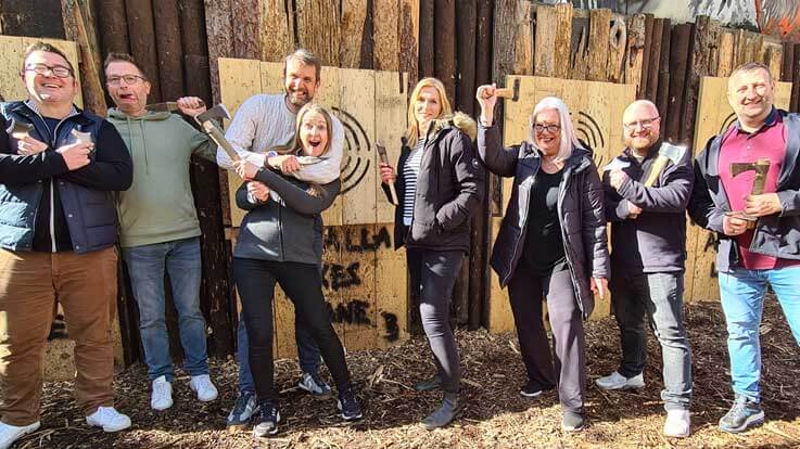 happy group on the axe throwing range