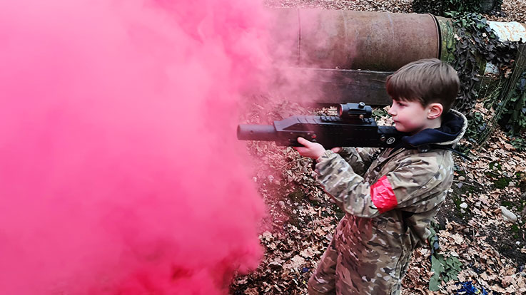 junior laser tag player in smoke