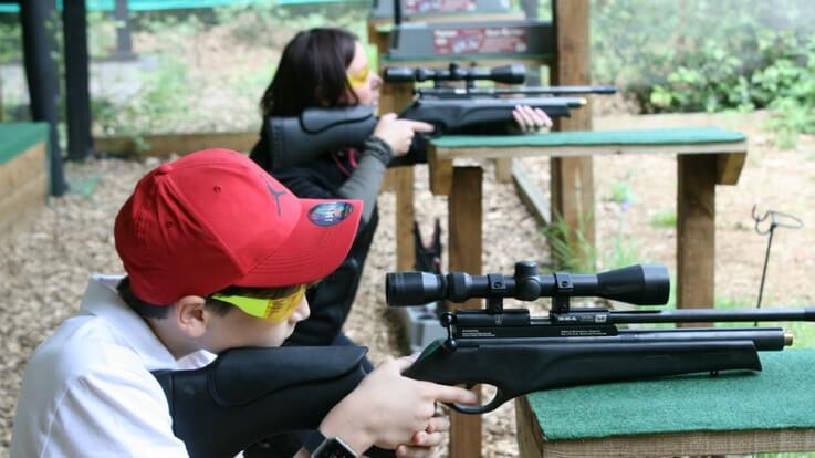 kid aiming rifle on rest