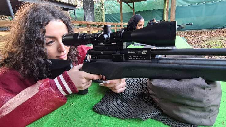 lady shooter taking aim with rifle