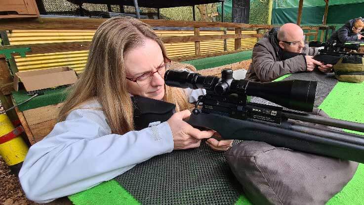 lady shooting rifle from the prone-position