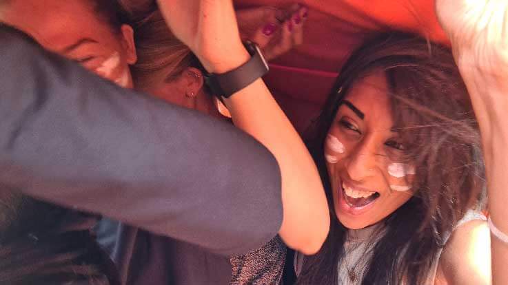 laughing while taking part in inflatable caterpillar trax