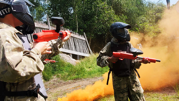 mini paintball players and orange smoke grenades