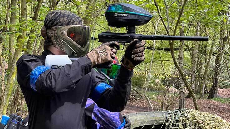 paintballer with own gear shooting across game zone