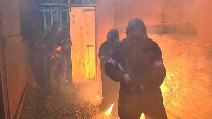 paintballers in embassy lit by smoke grenades
