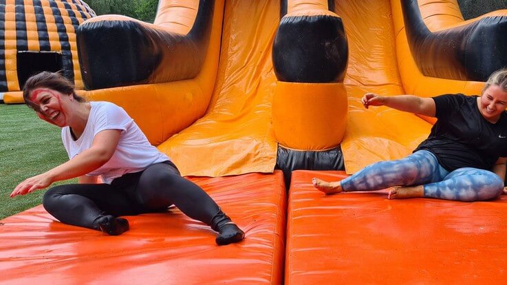 players on inflatable slide