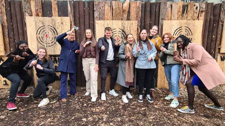 players posing by axe throwing targets