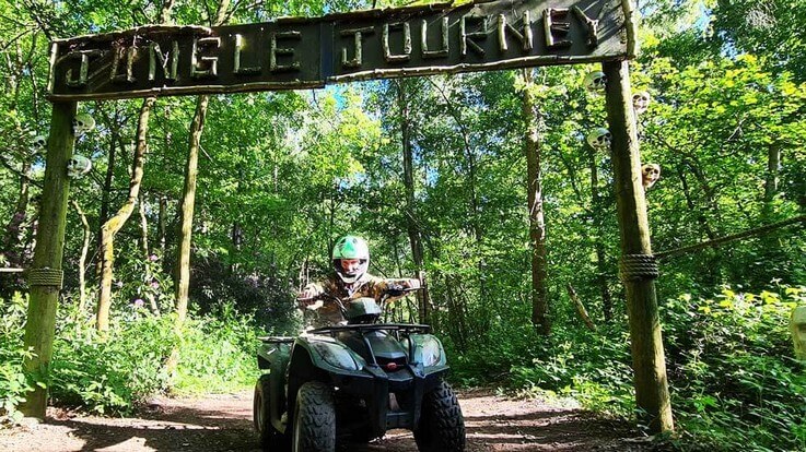 rider on quad under jungle journey sign