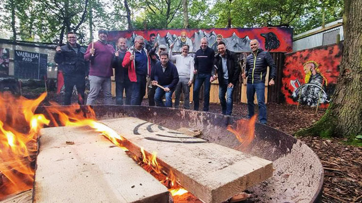 stag axe throwing group around fire pit