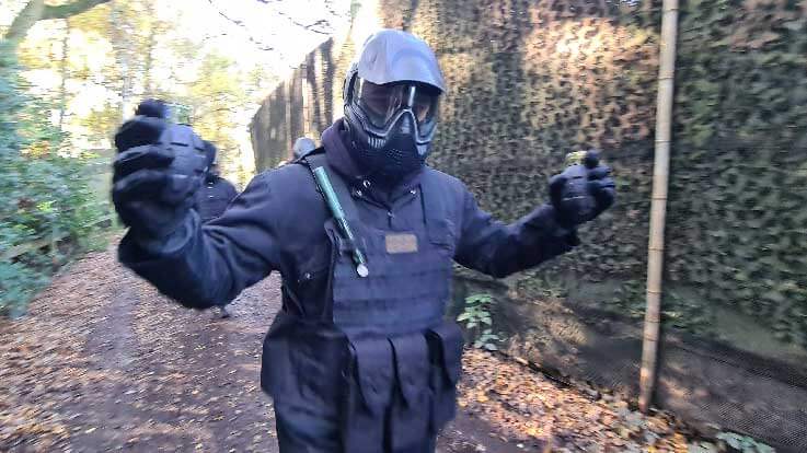 swat paintballer holding paint grenades
