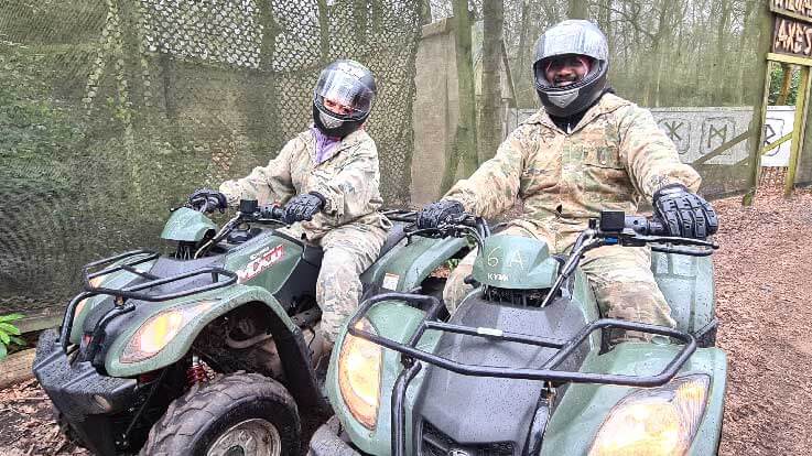 two riders sitting on quad bikes