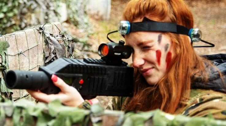 woman holding laser tag gun with headband